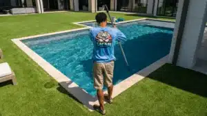 Technician cleaning pool