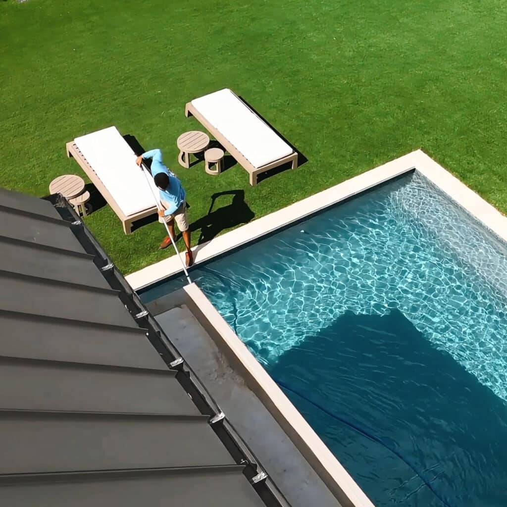 Top Corner View of Technician Cleaning Pool