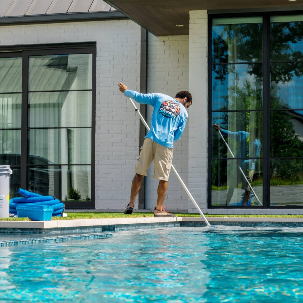 Safari Pools Service Technician Cleaning Clients Pool