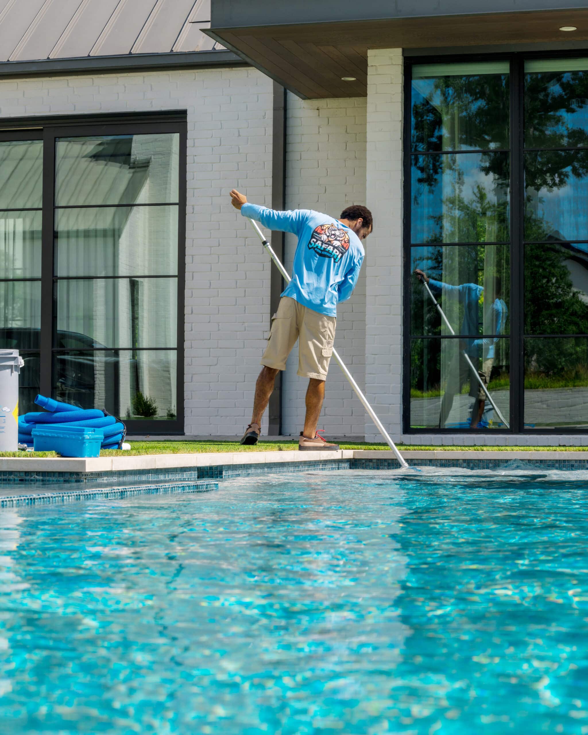 Technician from Safari Pools Service Cleaning Pool