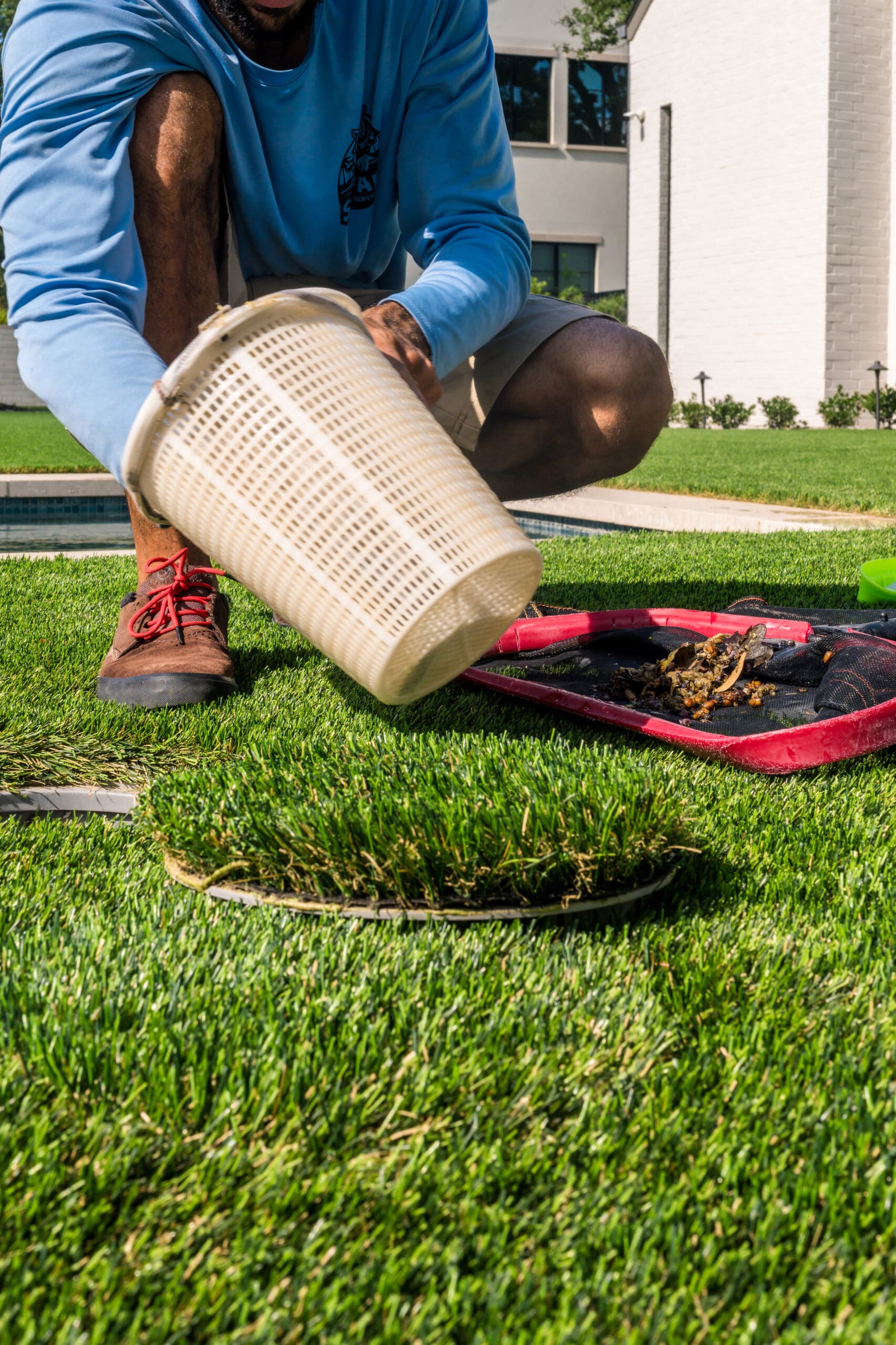Safari Pools Service Technician Removing Debris From Basket