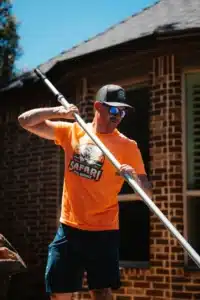 Safari Pool Service Tech Scrubbing Pool